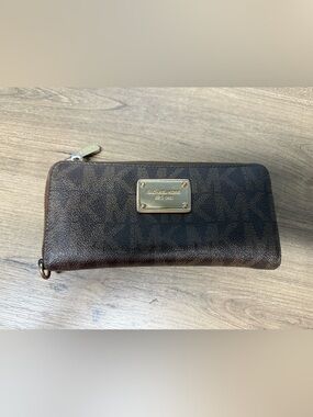 Michael Kors Dark Brown Monogram Zip wallet clutch with Gold Hardware